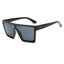 Maskulo NQ1374 Oversized Sunglasses with black frame and black shades, made of PVC/Acryl, offering UV400 protection.